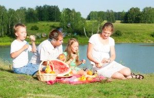 family resting on the lake