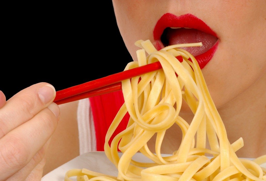 Close up Image of a Woman Eating Pasta