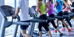 Group of people running on treadmills