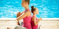 Mother and daughter doing exercise outdoors